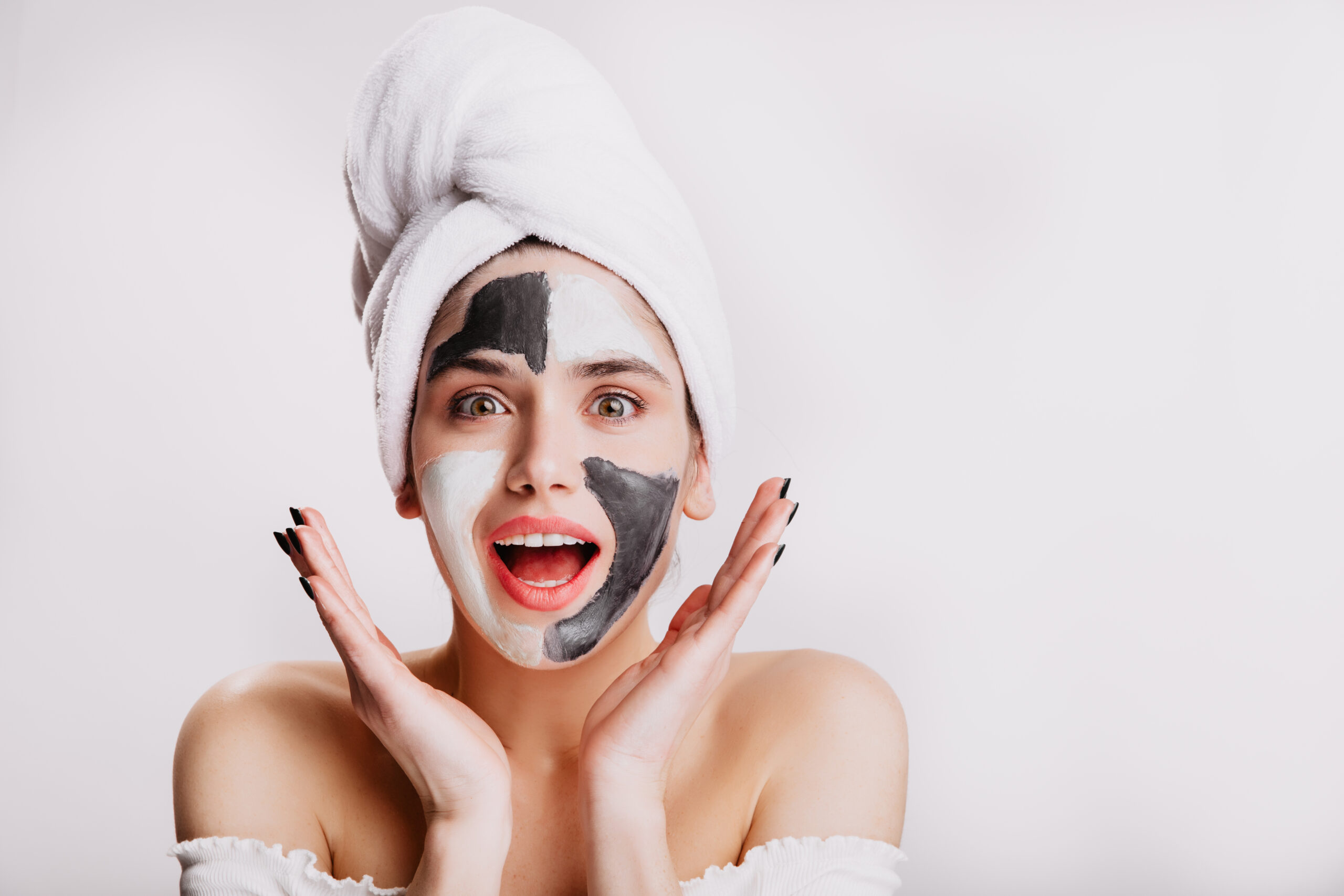 Joyful Girl With Face Mask Looks At Camera In Surprise Green Eyed Woman Posing On White Background After Washing Her Hair